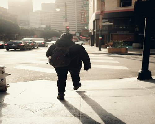 Person commuting through city streets in the morning