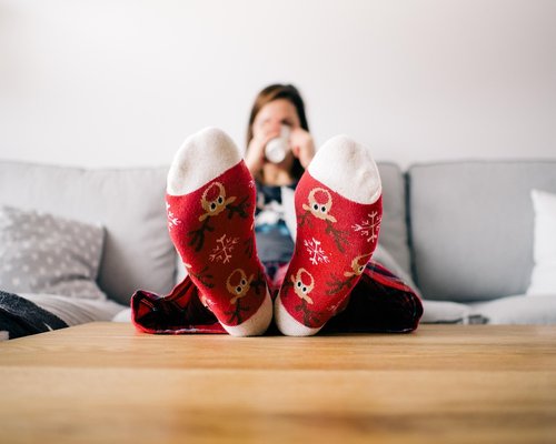 A relaxed person sitting properly at a cozy home desk